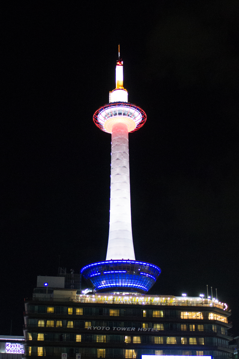 Kyoto Tower all lit up at night.